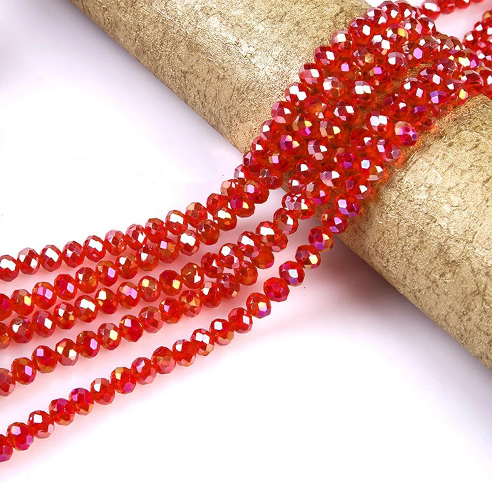 Red faceted crystal glass spacer beads strung on a gold-colored cord.