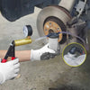 A hand uses a professional brake bleeder and vacuum pump kit with gauge to bleed a brake line on a bicycle wheel.