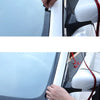 A hand is applying an automotive rubber sealing strip to a car window frame for noise and weather protection.