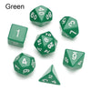 A set of green polyhedral dice including a d6, d8, d10, d12, and d20.