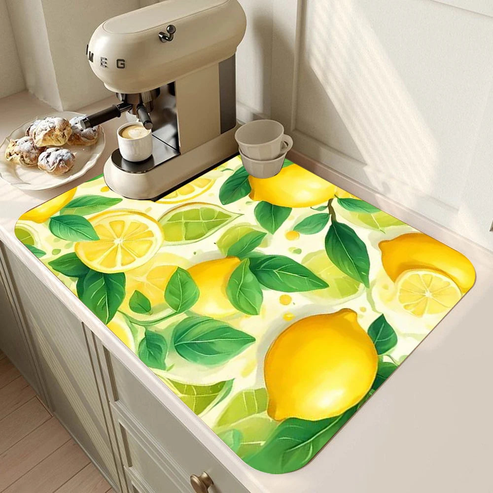 A yellow lemon print absorbent kitchen drying mat placed on a countertop next to a coffee grinder.
