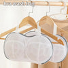 A white mesh bra wash bag is hanging on a wooden hanger.