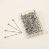 A clear plastic container holds a pack of 100 silver precision quilting pins for sewing and crafting.