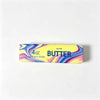 A yellow label for salted butter fidget stick, 4 oz net weight, with the word BUTTER printed on it.