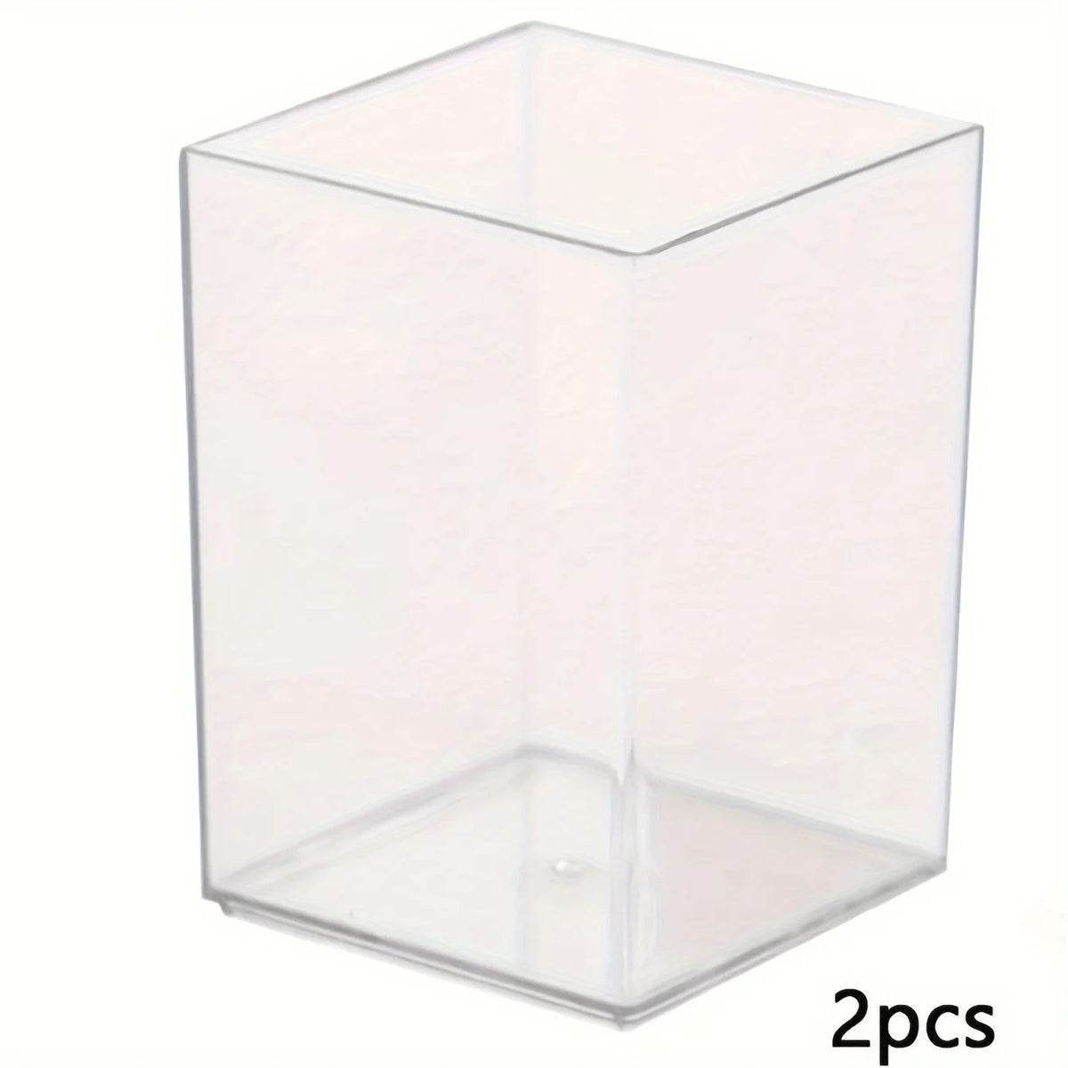 A clear acrylic rectangular pen holder with a slanted bottom, shown from above.