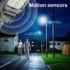 A solar street light with a motion sensor illuminates a pathway at night.