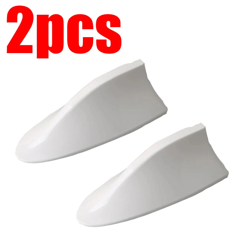 Two white shark fin car antennas for FM/AM signal enhancement