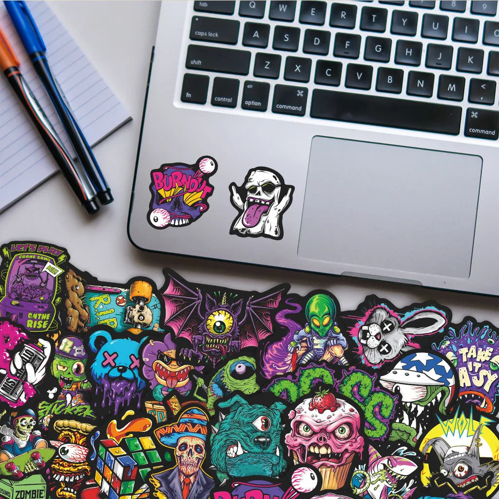 A collection of 55 colorful skull stickers featuring various designs on a laptop surface.