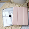 A pink slim protective iPad case with built-in pencil holder resting on a light fabric.