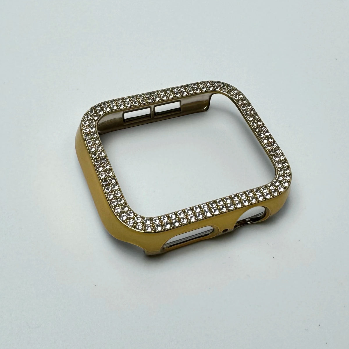 Funda de destello de diamantes de oro para Apple Watch, mostrada contra un fondo blanco.