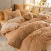 A luxurious beige plush mink velvet duvet cover set with sheets displayed on a bed.