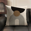 A beige linen cushion cover featuring a geometric design with black and tan shapes.