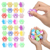 A hand holds various colorful squishy cat paw fidget toys for stress relief and sensory play.