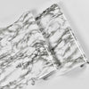 Roll of marble peel-and-stick wallpaper featuring gray and white veining