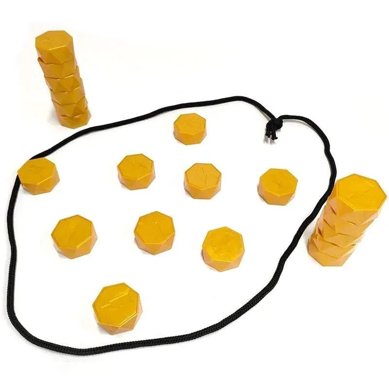 A collection of yellow magnetic stones stacked in a pyramid shape on a white cloth board.