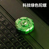 A green magnetic fidget slider is placed on a black computer keyboard.