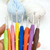 A hand holds an 8-piece crochet hook set with various colored ergonomic knitting needles.