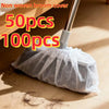 A bundle of 50 or 100 disposable non-woven broom covers being used to clean a wooden floor.