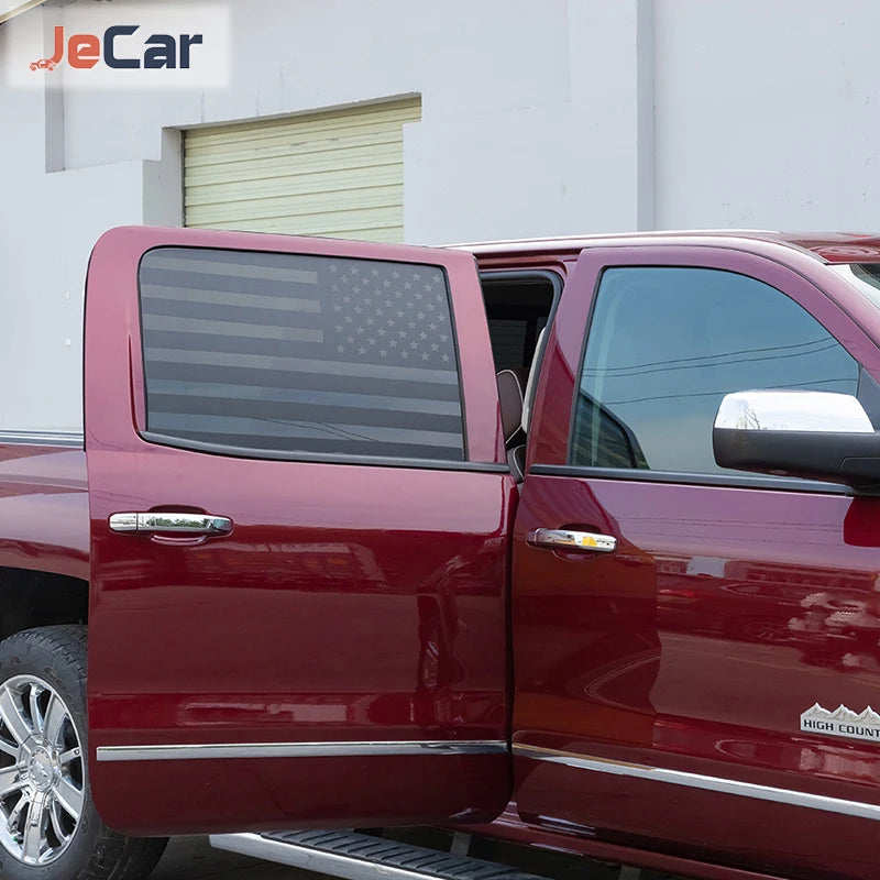 Close-up of a red Chevy Silverado or GMC Sierra truck with the rear window decorative trim cover installed.