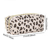 A beige leopard print double-zip pencil case with a gold zipper and a black and brown pattern.