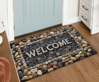 Inspirierendes rutschfestes Fußmatte mit dem Wort WELCOME in grauer Schrift auf dunklem Stein