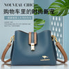 A dark blue leather shoulder bag with a gold clasp and tan strap, displayed against a light background.