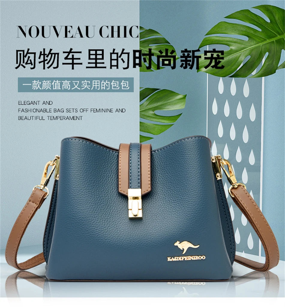 A dark blue leather shoulder bag with a gold clasp and tan strap, displayed against a light background.