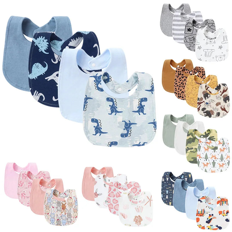 A collection of soft cotton baby bibs in various colors and cute cartoon prints.