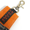 Orange heavy-duty cowhide welding rod storage bag with a metal hanging hook.
