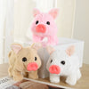 Three pink and white pig plush toys of different sizes displayed on a white box.