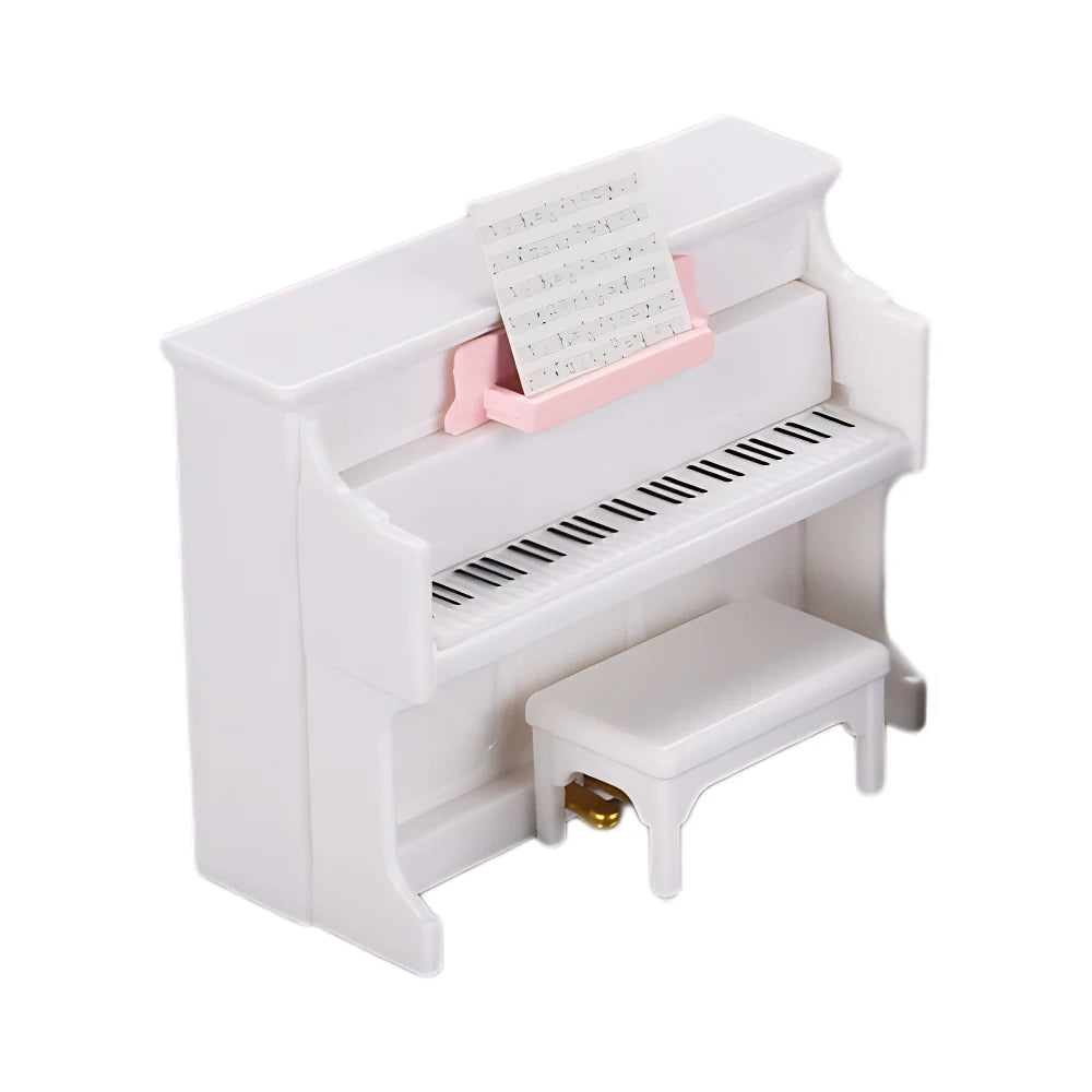 A white miniature piano accessory set with a pink music stand and keys.