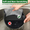A hand is using a soft, non-scratching dishcloth to clean a non-stick pan in a sink.