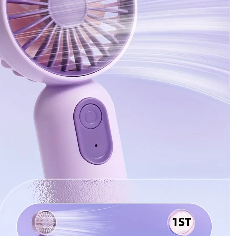 A close-up view of a light purple handheld fan with a grille and a power button, showing airflow lines.