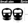 Two small black heavy duty car dent puller suction cups shown side by side.