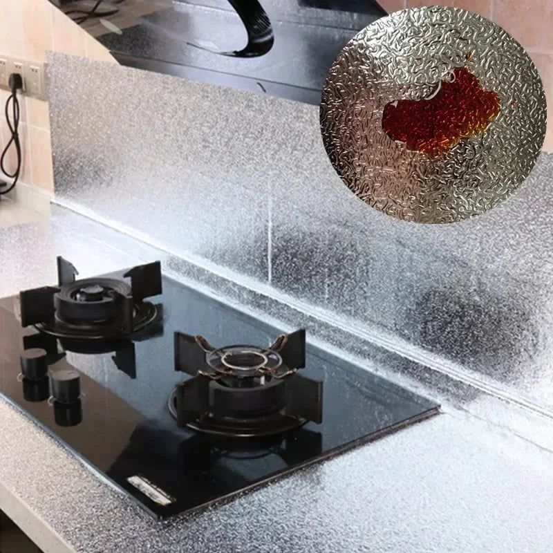 A kitchen countertop with a black induction cooktop and a silver textured backsplash liner.