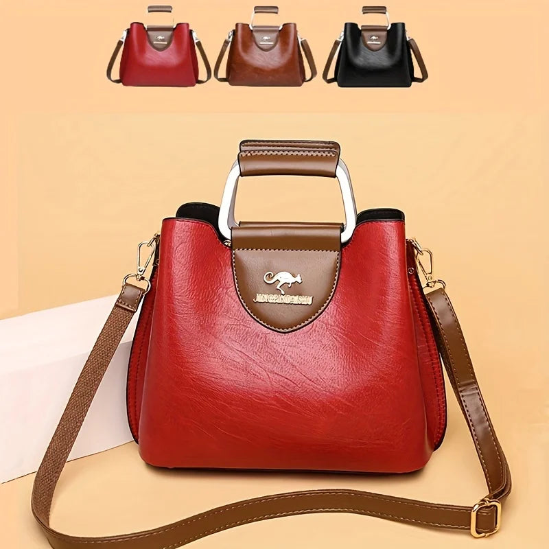A red leather crossbody tote bag with a brown strap and a flap closure, shown against a light background.