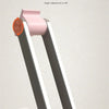 A pink acrylic tablet stand with a silver arm, demonstrating strong support and angle adjustment.