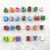 A set of 26 mixed alphabet letter beads in various colors and sizes for DIY jewelry making
