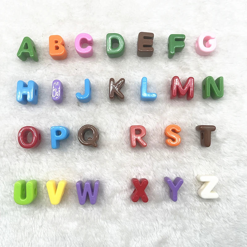 A set of 26 mixed alphabet letter beads in various colors and sizes for DIY jewelry making