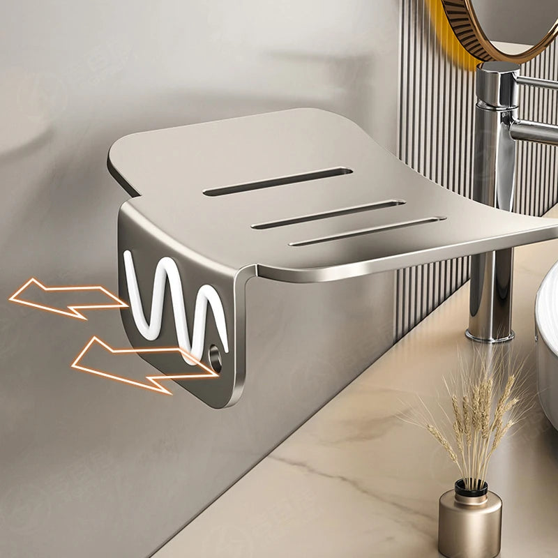 A silver aluminum wall-mounted soap dish with a drain is shown mounted on a wall.