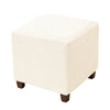 A square ottoman slipcover in off-white with a geometric woven pattern.