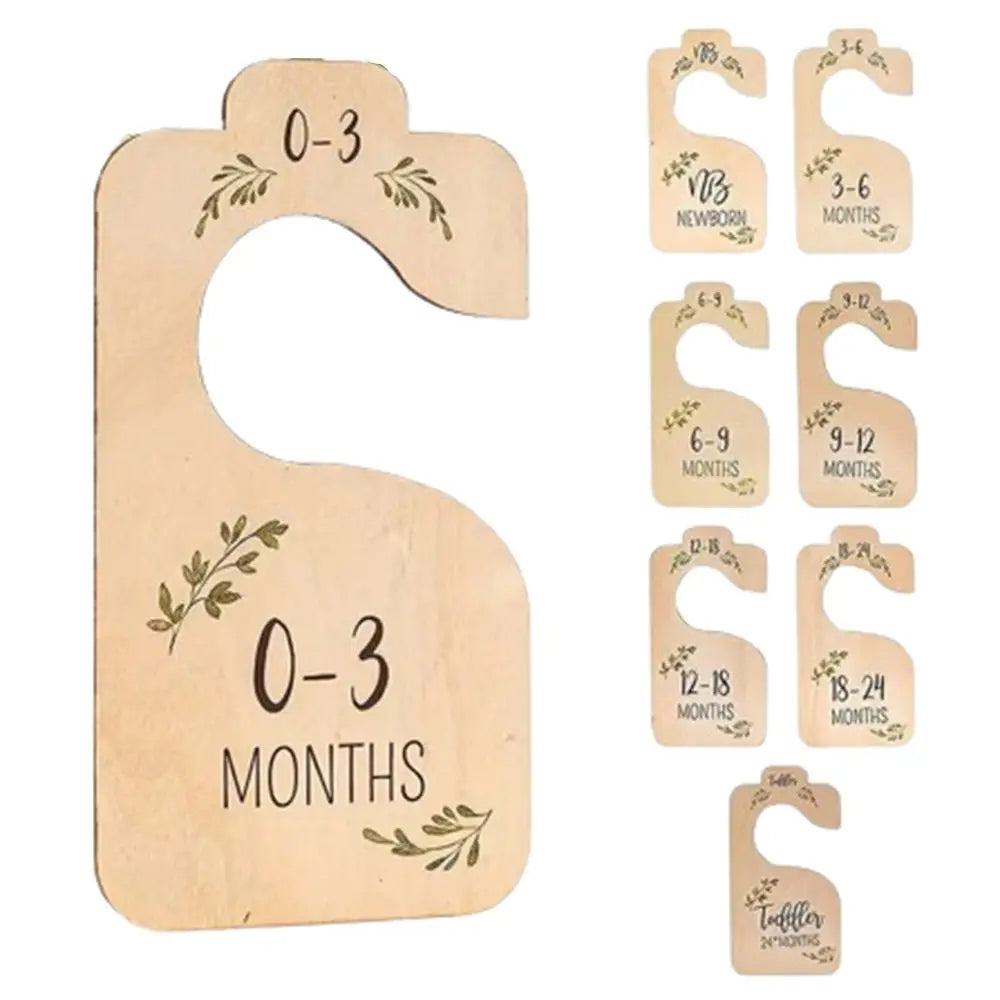 Wooden baby closet dividers with cartoon labels for age ranges 0-3 months to toddler