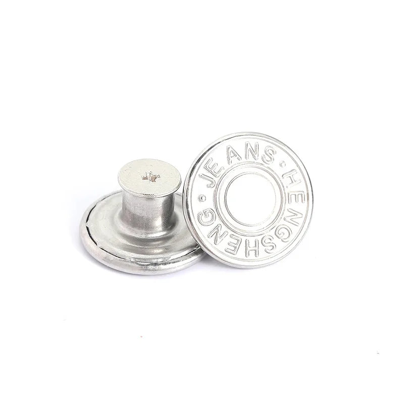 A silver metal button with the brand name Jeans engraved on it, shown against a white background.