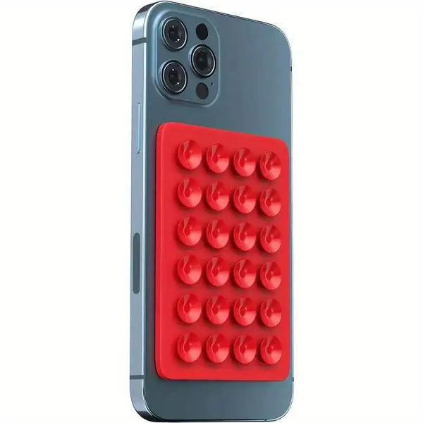 Un smartphone gris con una almohadilla de succión de silicona roja en el reverso.