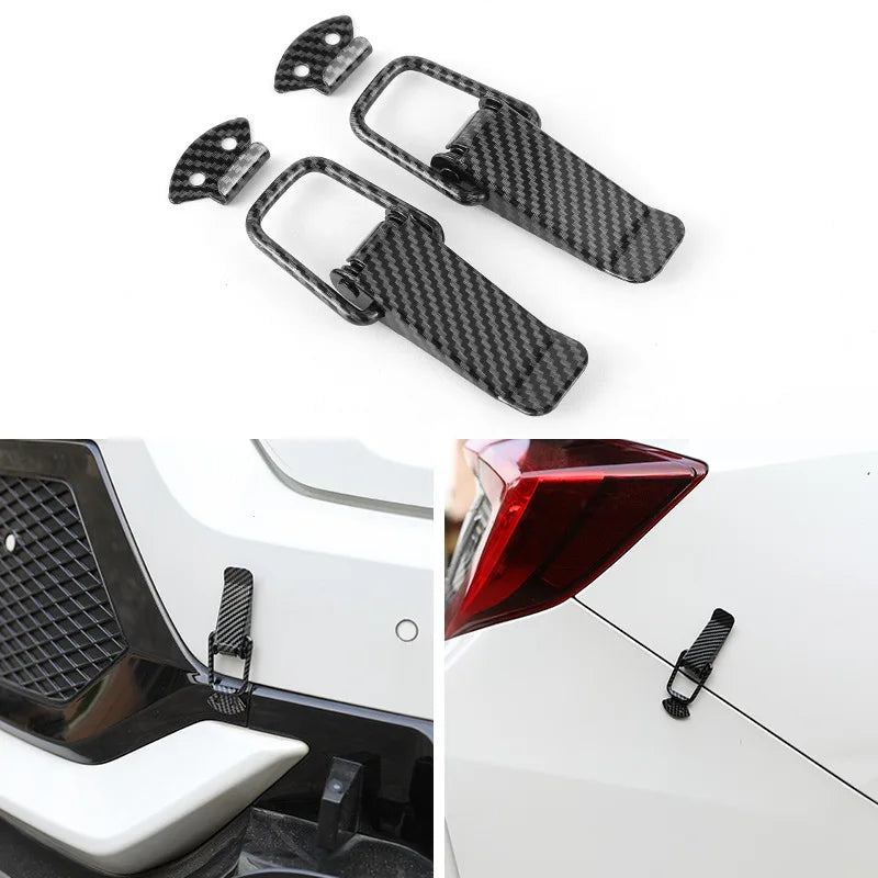 A set of carbon fiber rear trunk locking buckles and latch components for a car.