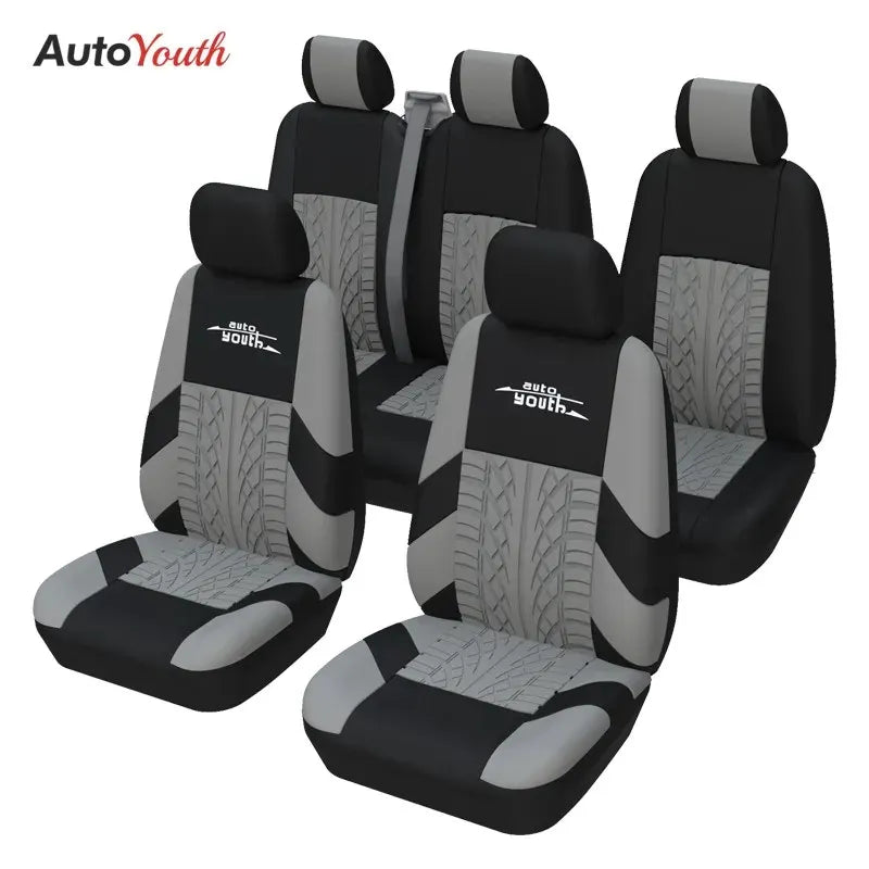 Four black car seat covers for two-row vehicles shown in a studio setting.