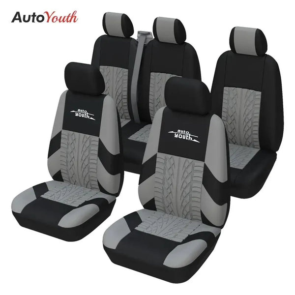 Four black car seat covers for two-row vehicles shown in a studio setting.
