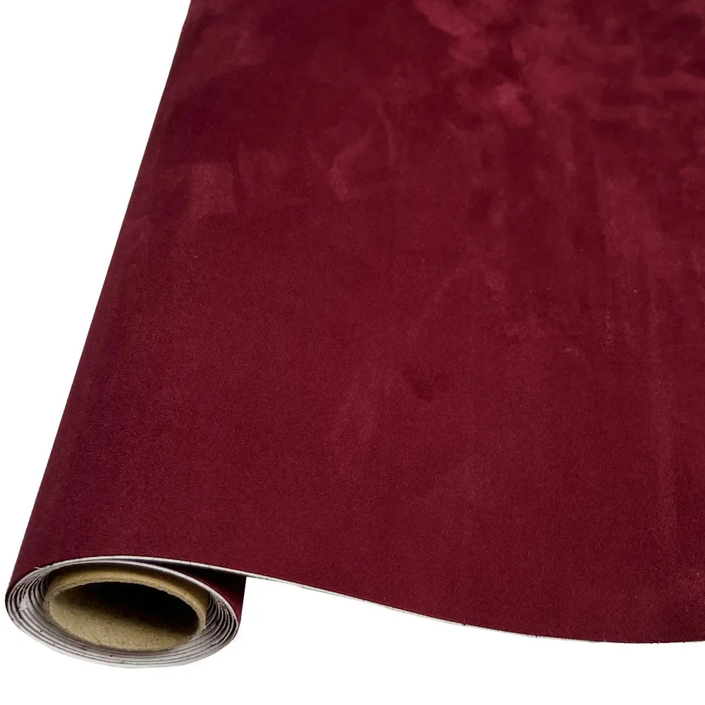 Roll of deep burgundy suede fabric for DIY car interior and home decor projects
