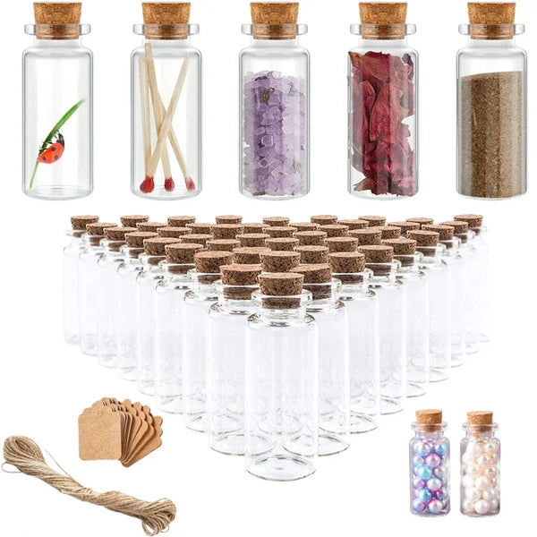 A collection of mini glass bottles with cork stoppers, some filled with colorful materials like glitter and dried flowers.