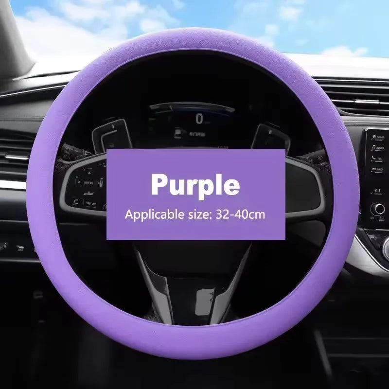 Purple silicone steering wheel cover for a car, showing the grip and rim.